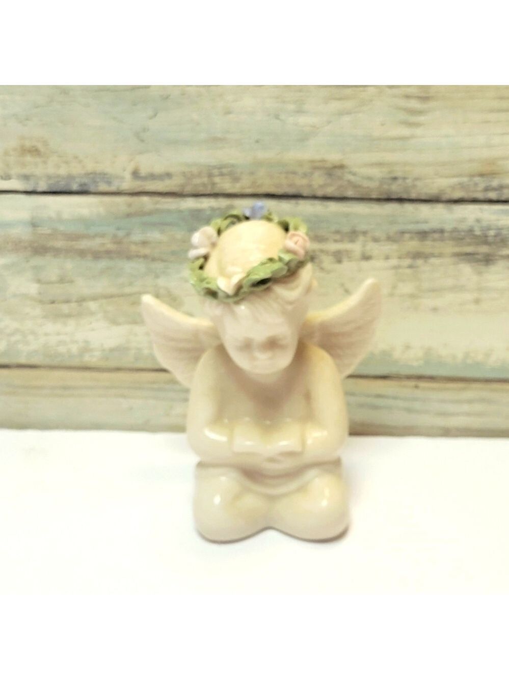Vintage Ceramic Angel Figurine with Floral Crown Bible